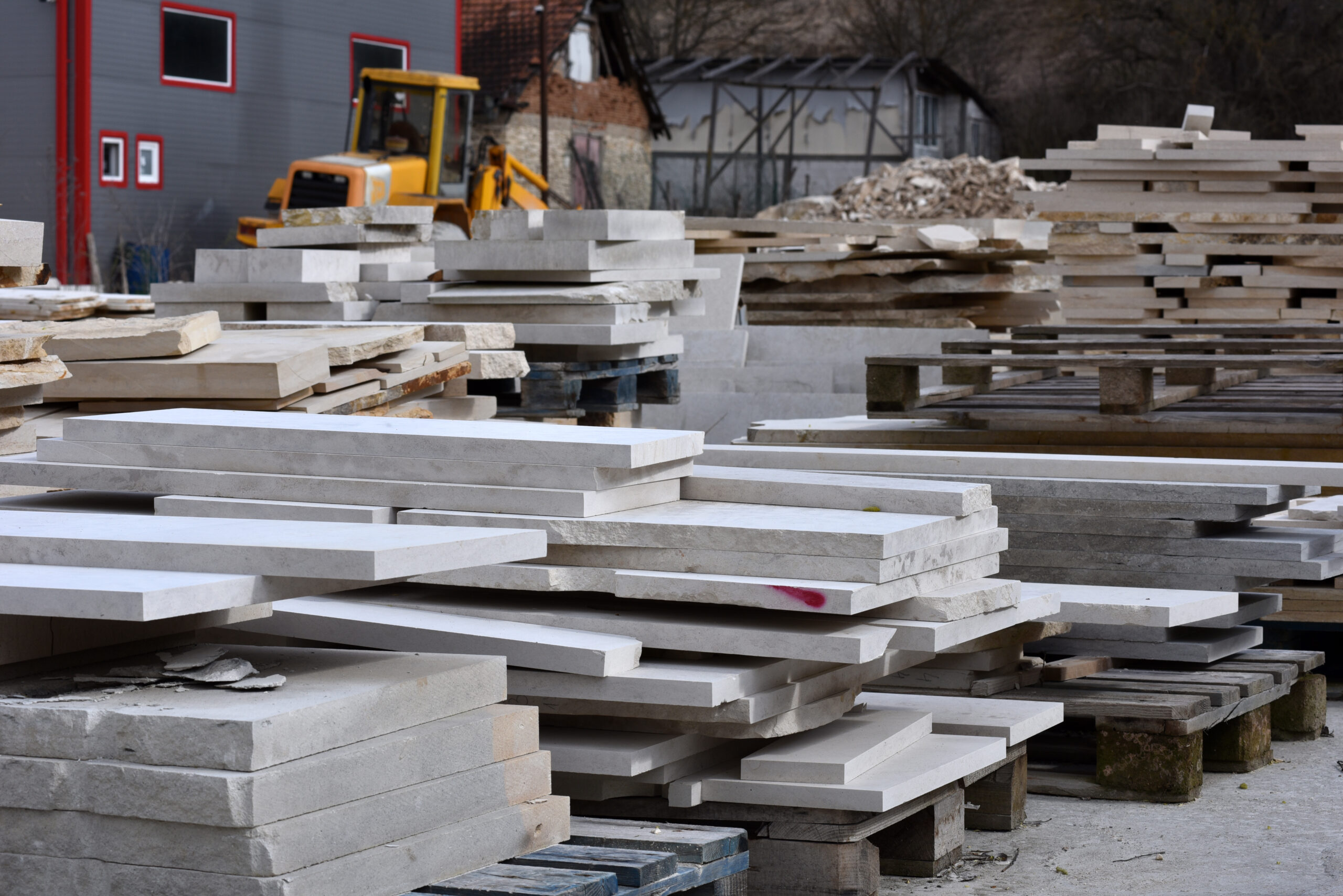 Workshop for the processing of stone products. Warehouse of decorative natural stone in the open air. Limestone cuttings for production