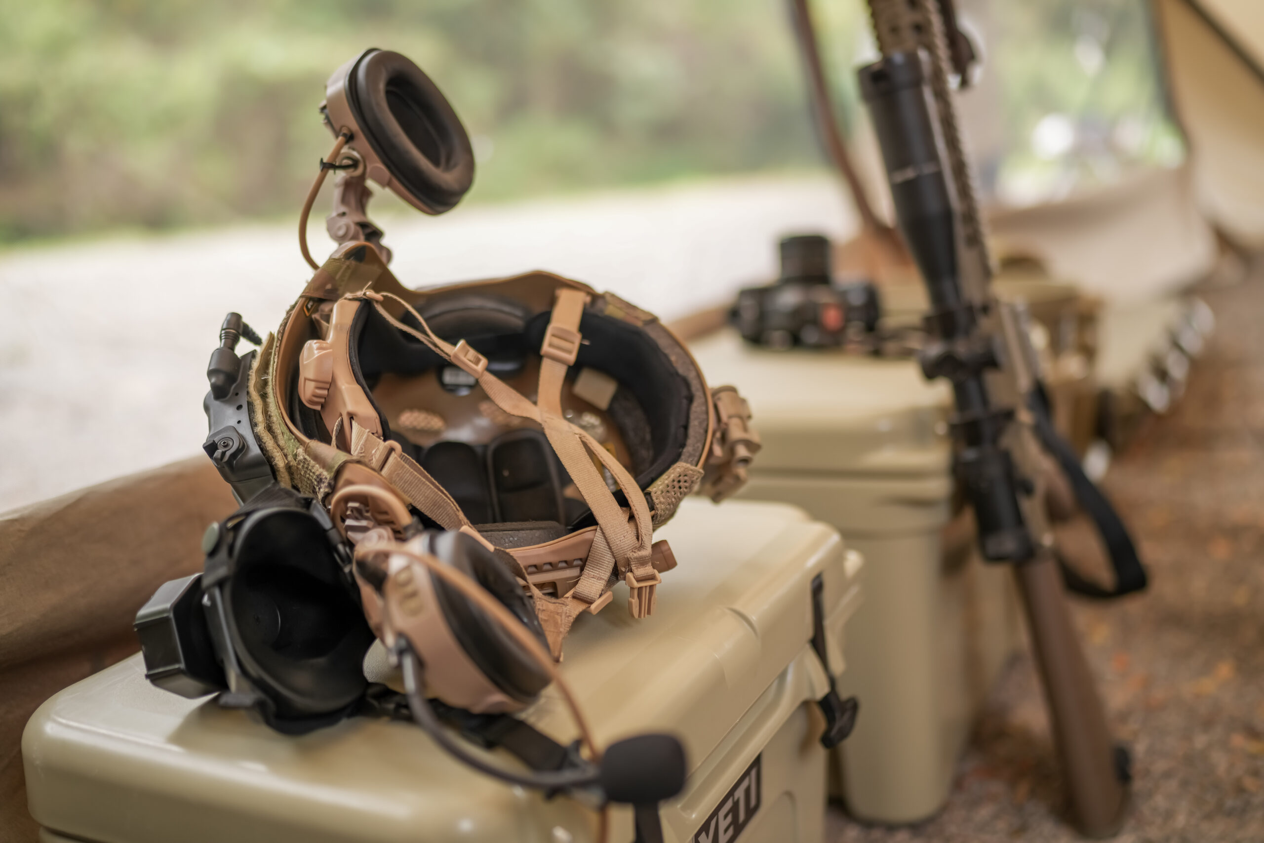 Army soldier shooting with firearm in battlefield. United States Army ranger during the military operation. Professional marine soldiers training with weapon on a military range.